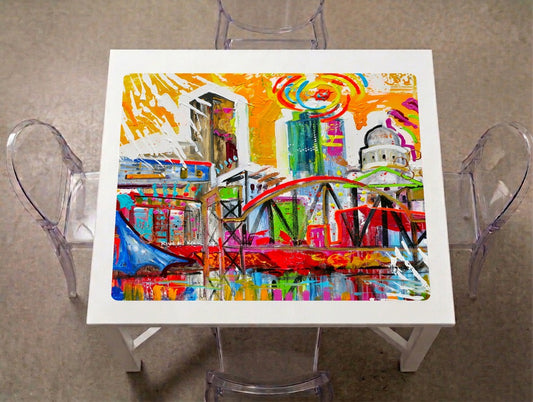 Little Rock River Market & Capitol Mahjong Mat on a game table with acrylic chairs