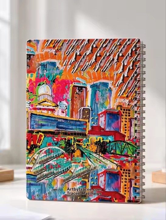 Little Rock Skyline art notebook by Tracee Gentry Matthews, spiral notebook on a table